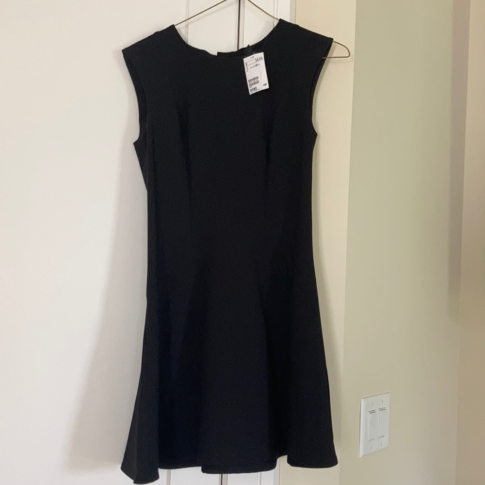 NEW Sleeveless black dress with flared skirt.